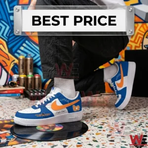 A low angle shot of a person kneeling in a room with graffiti, wearing custom blue and white sneakers with orange swooshes.
