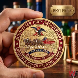 A hand holding a Budweiser 150th Anniversary gold commemorative coin.