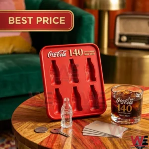 A red anniversary ice tray with bottle molds is displayed on a table with a drink and small personal items!