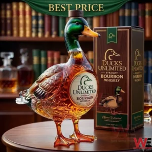 Ducks Unlimited straight bourbon whiskey in a unique mallard duck-shaped glass decanter on a wooden table.