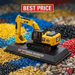 Caterpillar 100th anniversary edition scale model hydraulic excavator on plastic pellet background
