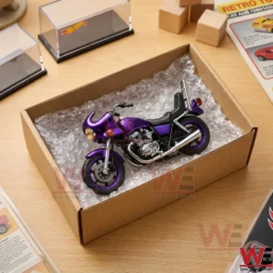 A purple collectible motorcycle model displayed inside a bubble-wrapped cardboard box.