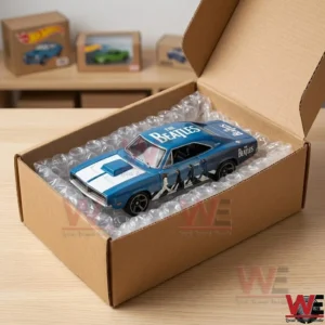 A limited edition Beatles-themed Dodge Charger die-cast toy car inside a shipping box