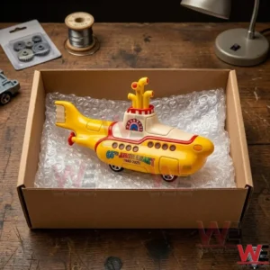 Yellow submarine 65th anniversary commemorative collectible inside a cardboard box.