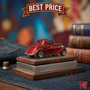 A red vintage die-cast car model resting on a wooden and metal tiered display base.