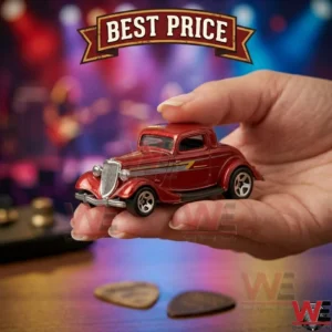 A hand holding a metallic red vintage hot rod toy car with a colorful bokeh background.
