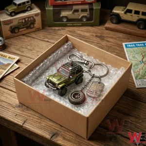Cardboard shipping box containing a miniature Jeep model and keychain protected by bubble wrap on a wooden desk!