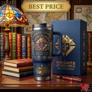 A blue knights of columbus tumbler and box on a desk with a lamp and books!