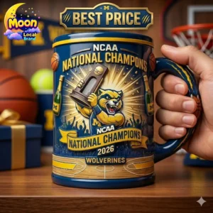 Michigan Wolverines NCAA National Champions 2026 commemorative coffee mug held in hand