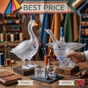 Two collectible Grey Goose vodka bottles shaped like geese sitting on a workbench.