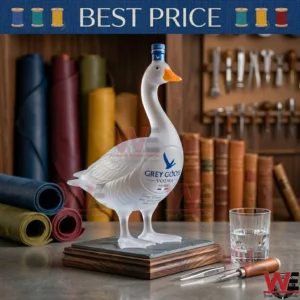 NEW Grey Goose Vodka 30th Anniversary 1996-2026 Glass Bottle 7 A decorative Grey Goose vodka bottle shaped like a goose on a wooden base with leather rolls.