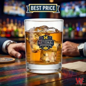 University of Michigan 2026 National Champions rocks glass with ice on a wooden bar.