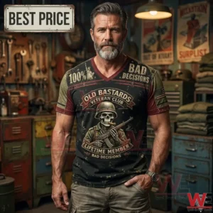 Middle-aged man with a gray beard wearing an Old Bastards Veteran Club graphic t-shirt in a garage workshop.
