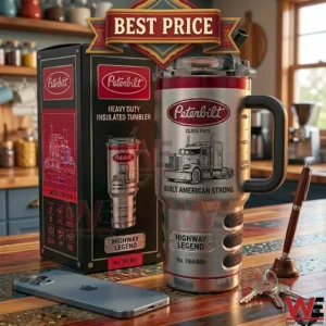 Brushed metal tumbler with Peterbilt truck logo and a handle sitting on a table next to its packaging!
