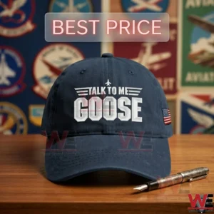 Navy blue baseball cap with white talk to me goose text and an american flag patch on a wooden table!