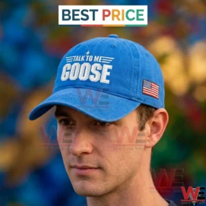 Side profile of a man wearing a royal blue baseball cap with white talk to me goose text!