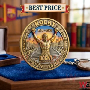A golden Rocky 50th anniversary commemorative coin with a boxer in a victory pose.