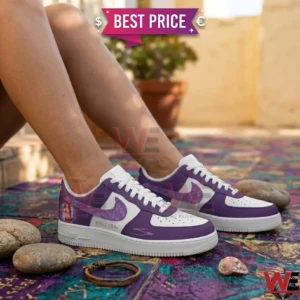 Person wearing custom purple and white Shakira-themed sneakers.
