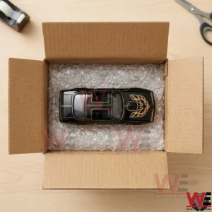Die-cast model Pontiac Firebird in a shipping box with protective bubble wrap.