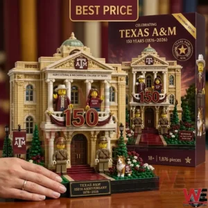 The completed building model stands next to its large maroon product box on a wooden surface!
