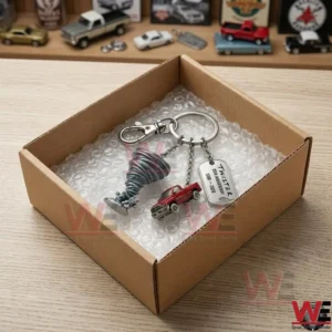 A commemorative movie keychain featuring a tornado funnel packed in a shipping box with bubble wrap.