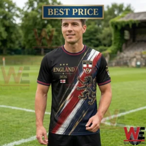 2026 FIFA World Cup UK Football Lover England T-Shirt 4 A man wearing a black England 2026 soccer jersey with a lion crest on a grass field.