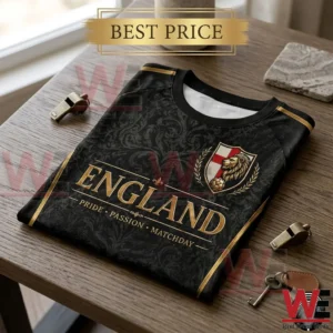 England soccer fan shirt with gold text and heraldic lion emblem on a wooden surface