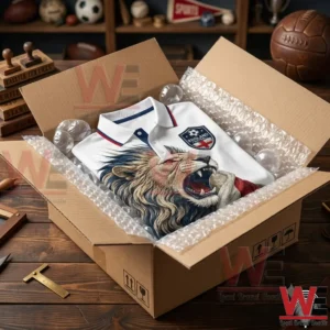 England football polo shirt featuring a lion design inside a shipping box